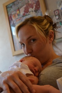 Mom kissing baby
