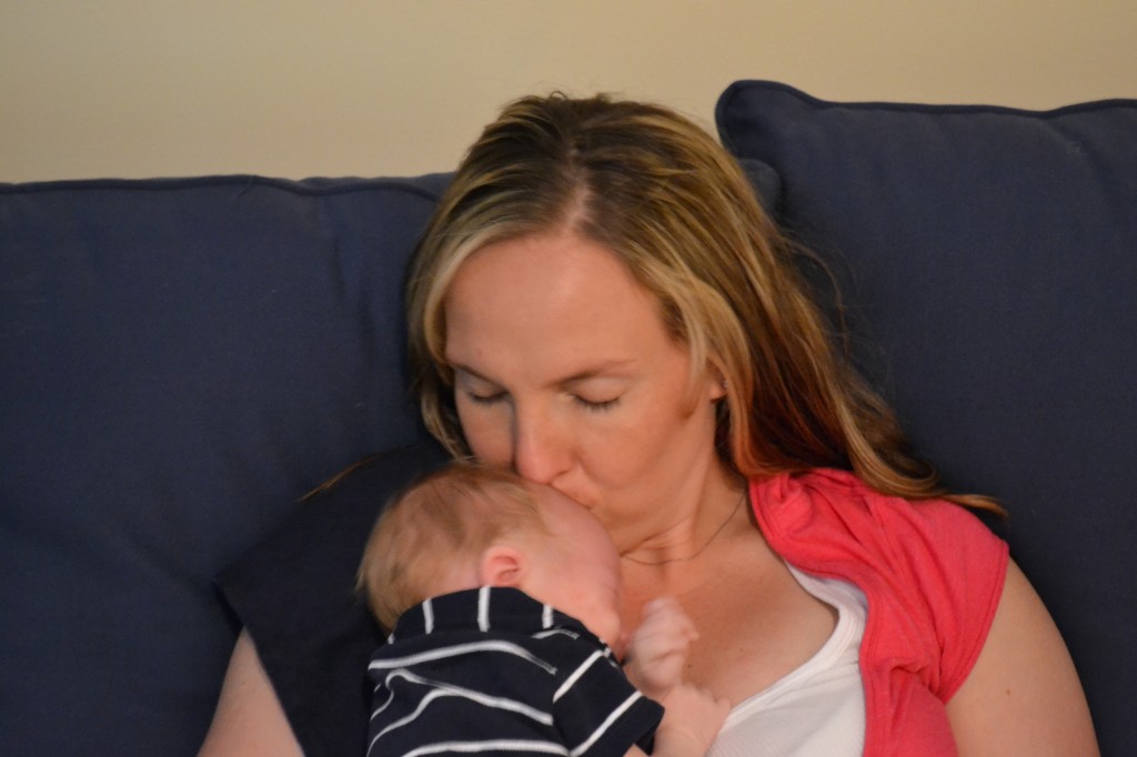 Mom kissing newborn baby boy