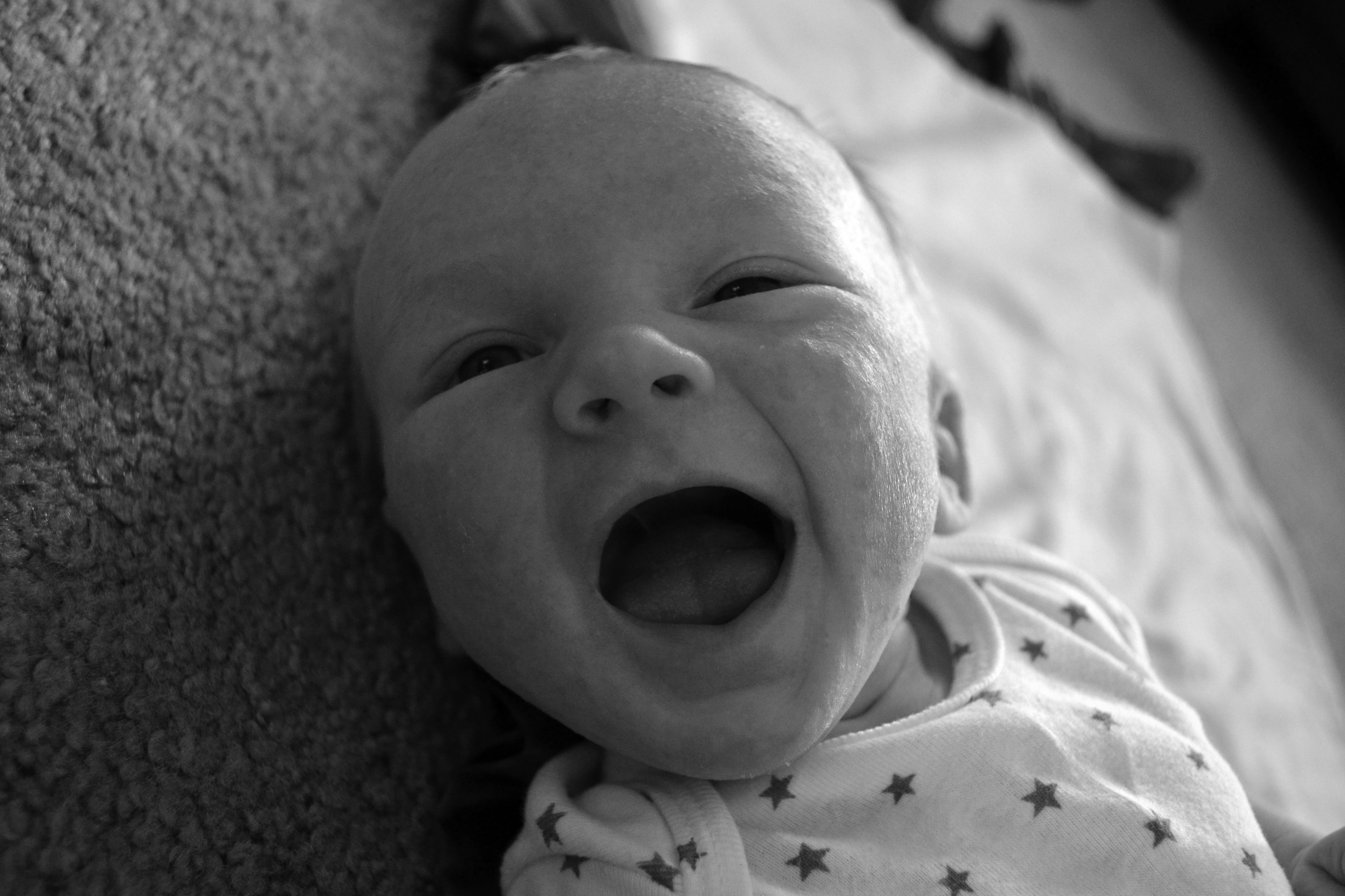 Newborn baby boy smiles
