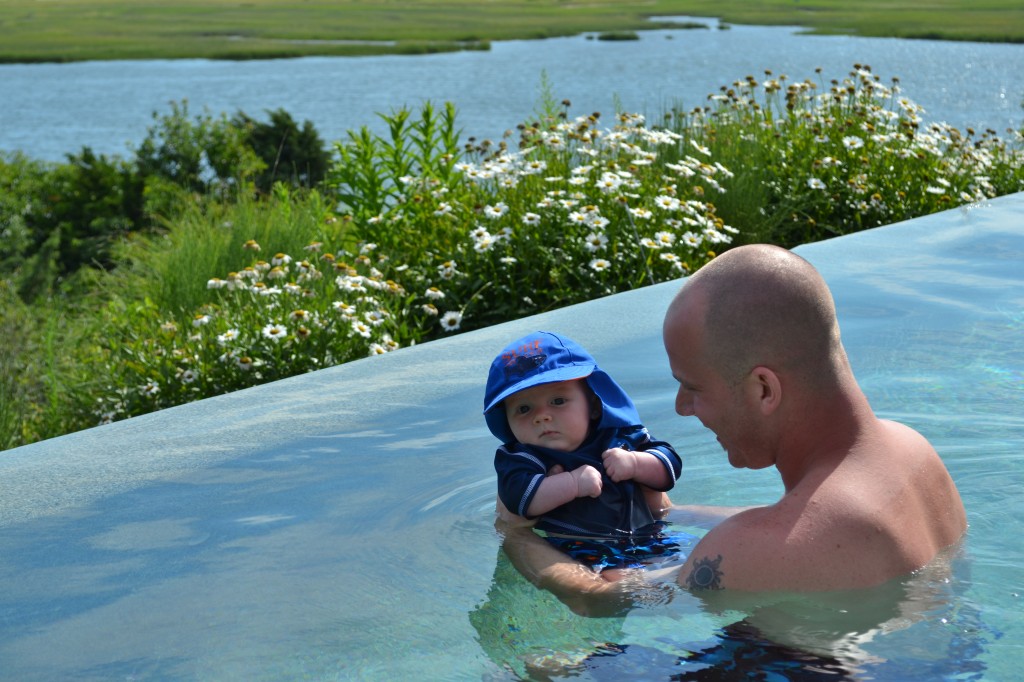 Baby swimming with daddy