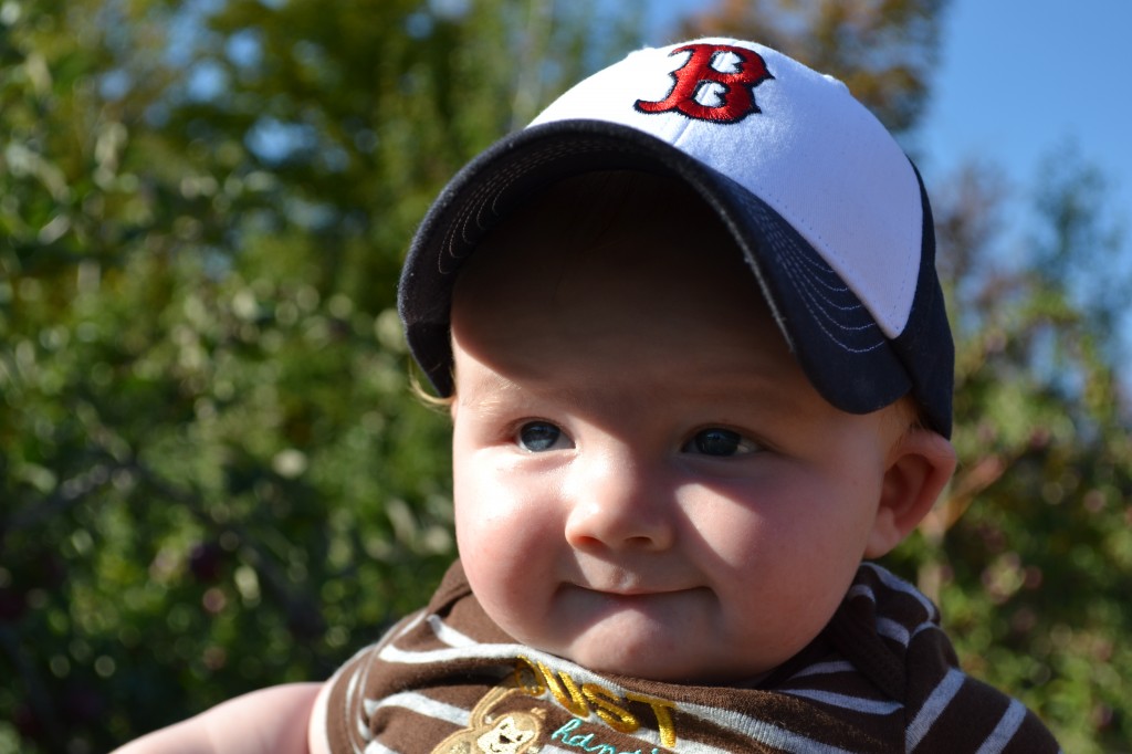 Smiling baby boy in the fall sun