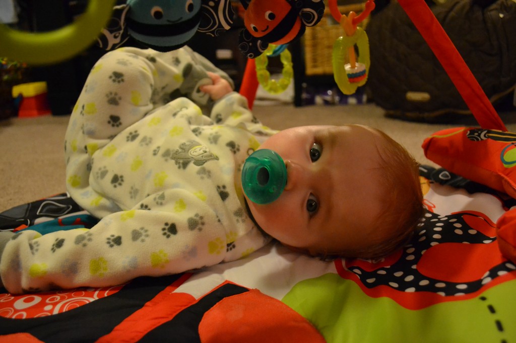 Baby grabbing his toes in pjs