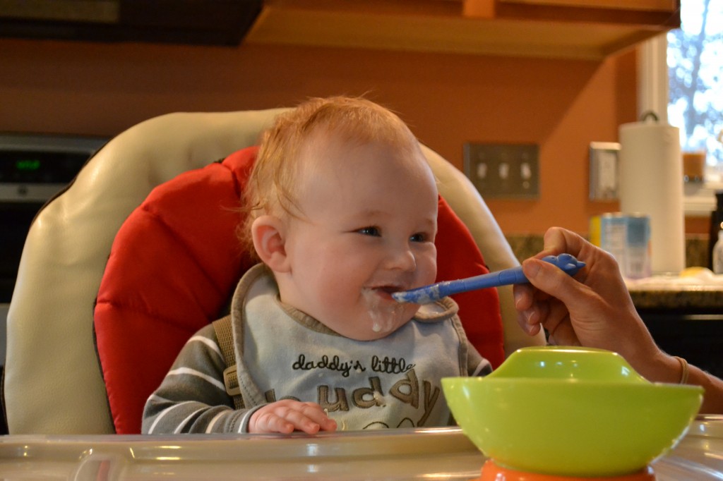 Cute baby eating first foods