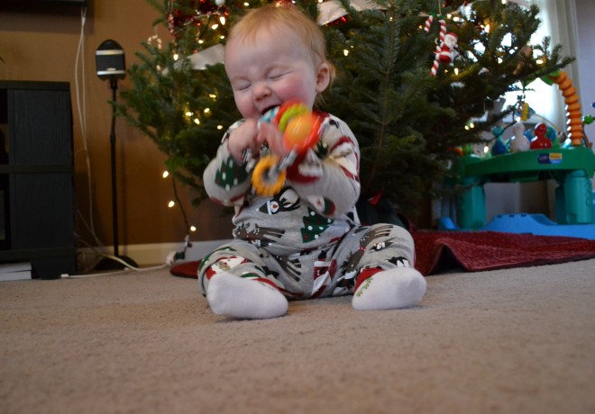 Baby playing with rattle on first Christmas