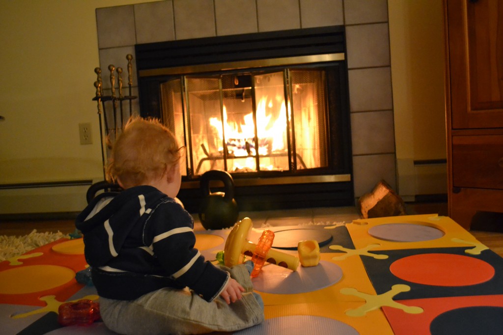 Baby sitting in front of the fire