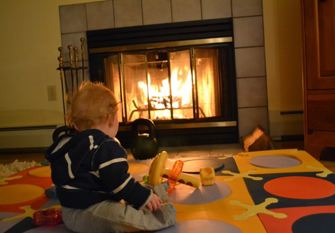 Baby sitting in front of the fire