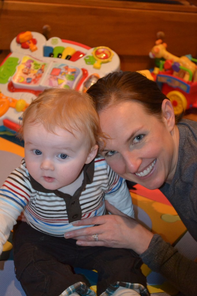 Baby sitting up and mom playing