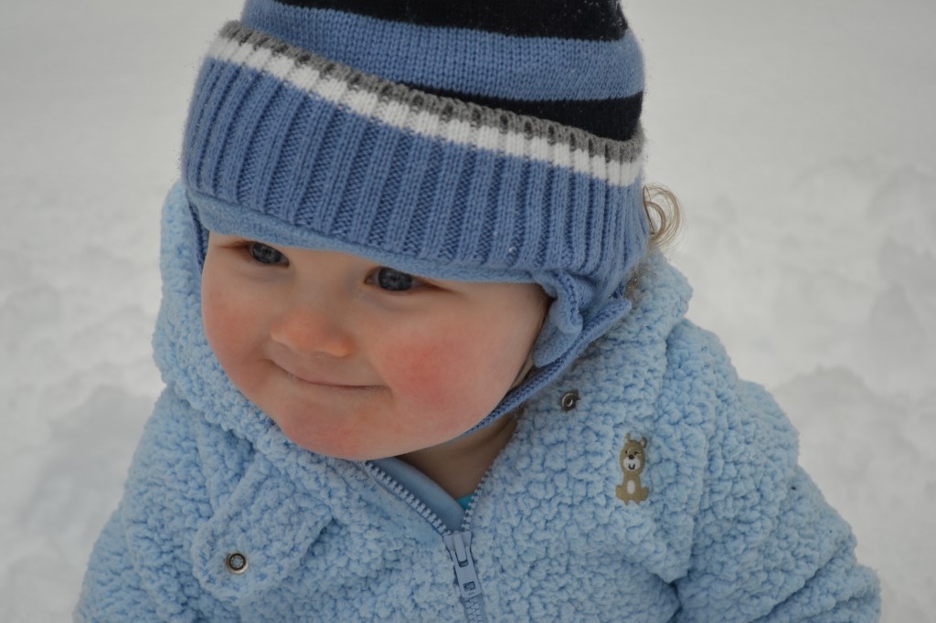 Baby making cute face in the snow