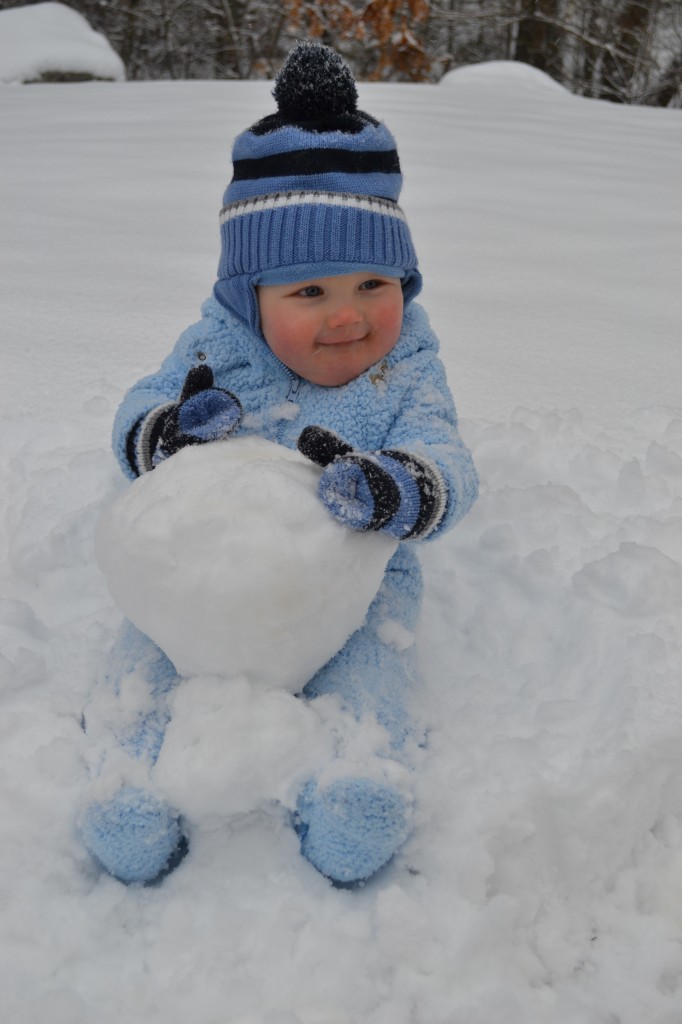 Baby Holding Big Snowball