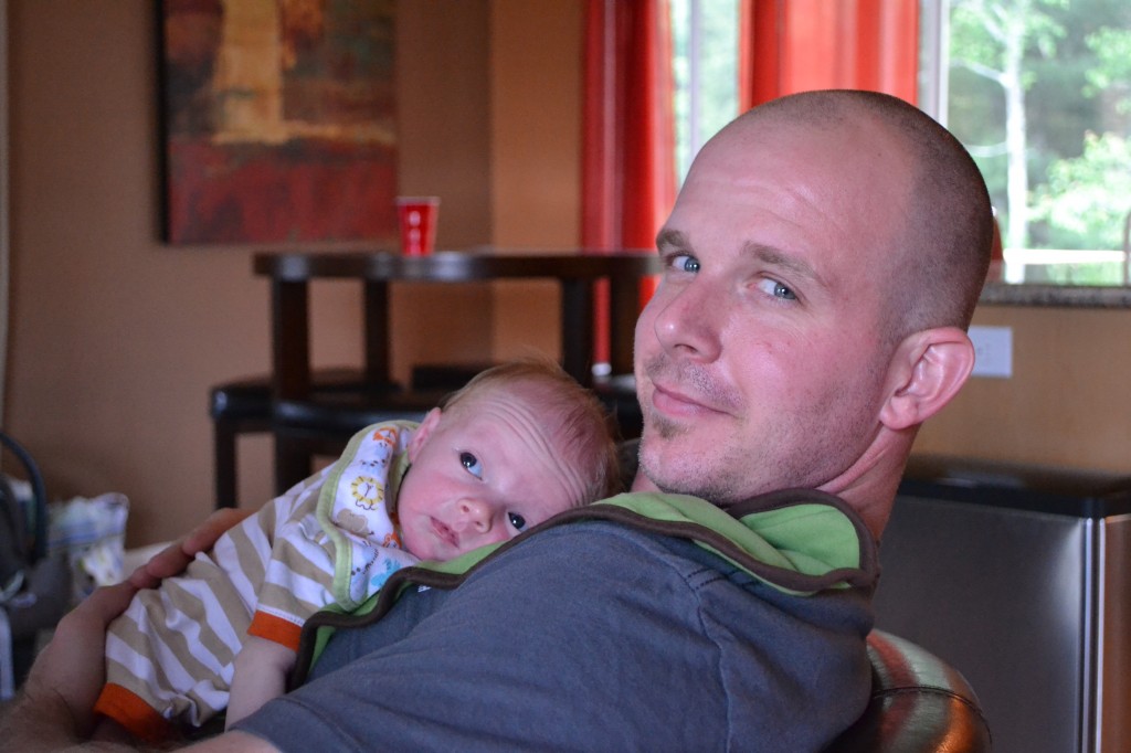 Dad Relaxing with Newborn Baby