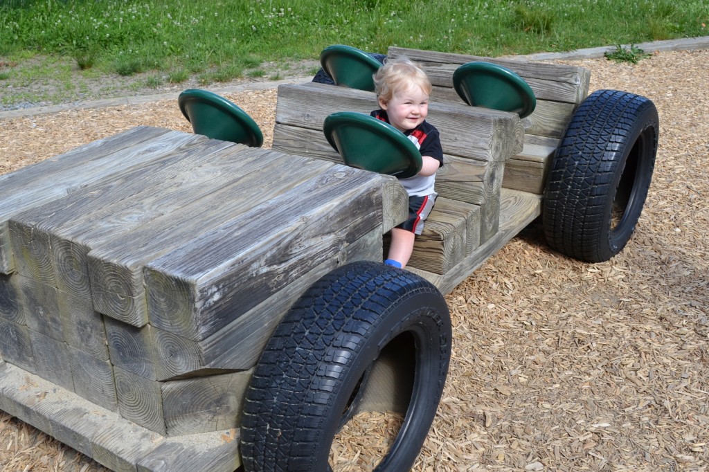 Baby in Wood Car At Playground
