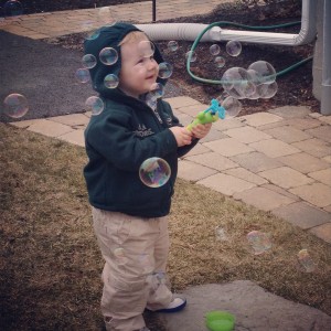 Two Year Old with Bubbles Outside